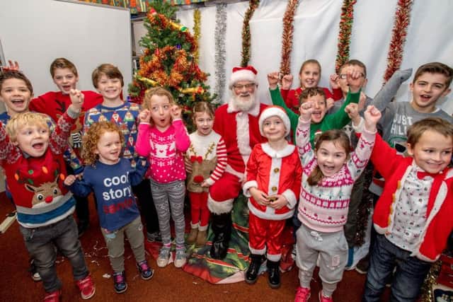 Excited children welcomed Santa for breakfast and helped raise £526 for Friends of School funds. PHOTO: John Aron.