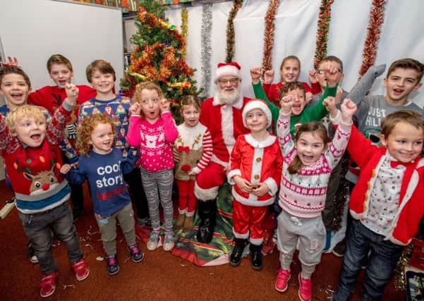 Excited children welcomed Santa for breakfast and helped raise Â£526 for Friends of School funds. PHOTO: John Aron.