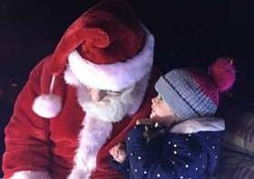 Santa learning secrets from youngsters.