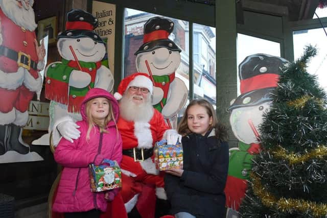 Mablethorpe Christmas Market. L-R Violet Walton,(7), and Emily Walton,(10), of Louth with Father Christmas.