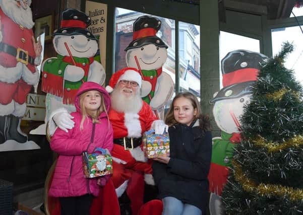 Mablethorpe Christmas Market. L-R Violet Walton,(7), and Emily Walton,(10), of Louth with Father Christmas.