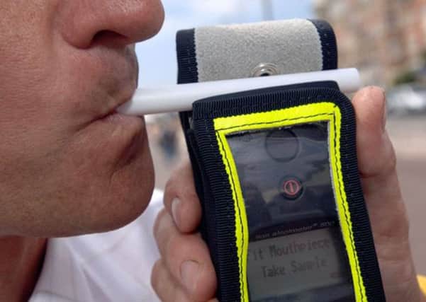 A motorist takes and passes a breath test during a patrol on Saturday night