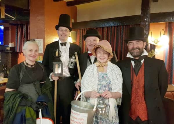Jo Johnston, Mike Eckersley, Keith Winnard, Emma Eckersley and  Fr Robert Thacker in the Aston Arms on their carolling tour of the town EMN-171218-123547001