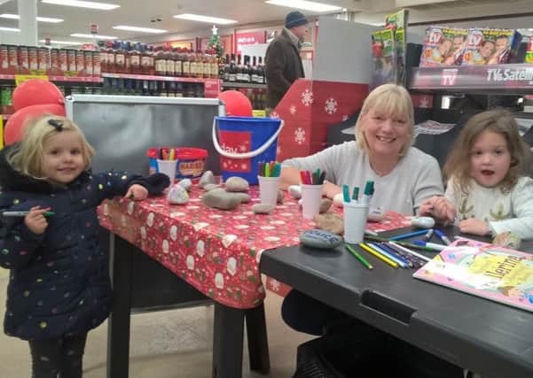 Mrs Pallett is pictured with three-year-olds Isla Nickless (right) and Hetty Conduit who obviously enjoyed painting more than shopping.