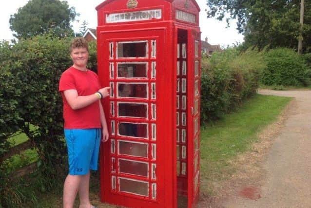 George Fleetwood midway through refurbishing the telephone box earlier this year EMN-171219-082635001