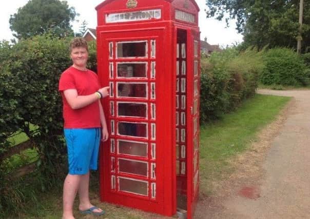 George Fleetwood midway through refurbishing the telephone box earlier this year EMN-171219-082635001