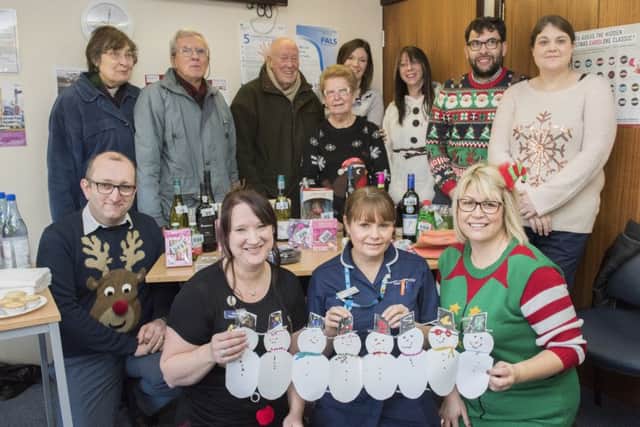 Staff and patients at Heckington's Millview Surgery get all festive wearing Christmas jumpers, raising money on the tombola / guess how many chocolate coins in the jar as well as inviting local school children to make festive decorations.
Picture: Sarah Washbourn/www.yellowbellyphotos.com EMN-171221-101619001