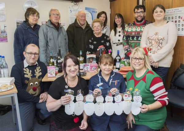 Staff and patients at Heckington's Millview Surgery get all festive wearing Christmas jumpers, raising money on the tombola / guess how many chocolate coins in the jar as well as inviting local school children to make festive decorations.
Picture: Sarah Washbourn/www.yellowbellyphotos.com EMN-171221-101619001