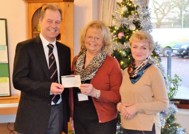 Alastair Huteson (left) and hsi wife Diane (right) are pictured presenting the cheque to Hospice Fundraiser Anne Millettat Lindsey Lodge Hospice EMN-171219-131238001