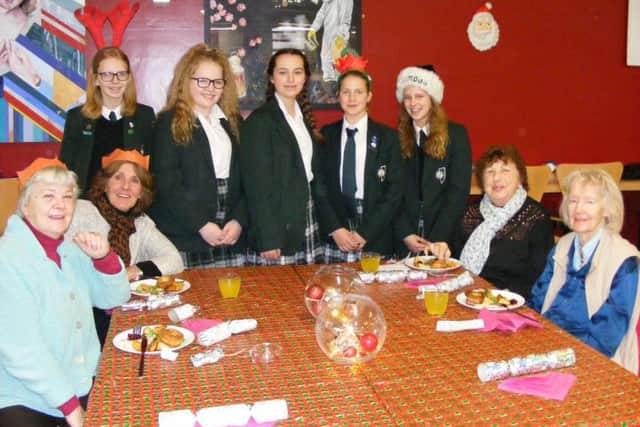 Serving up Christmas meals to Sleaford's older residents, from left - Nelly McArthur - Year 9, Megan Dillon - Year 10, Lucy Kinnersley - Year 10, Becky Creedon - Year 7 and Ella Marshall - Year 9, with Kay Grant, Pamela Thorne, Sue Gilman and Maureen Prior. EMN-171220-164033001