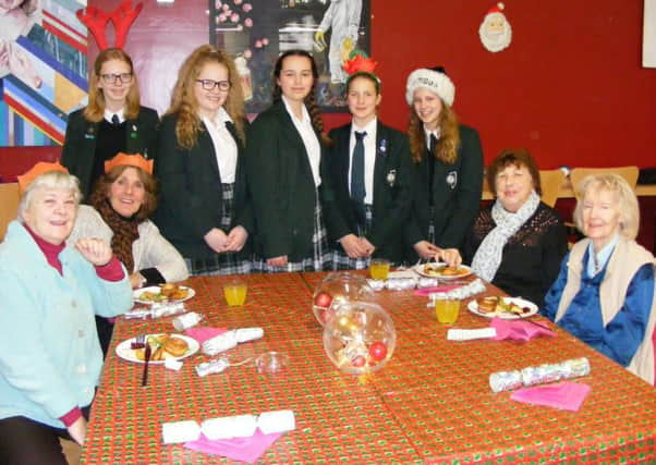Serving up Christmas meals to Sleaford's older residents, from left - Nelly McArthur - Year 9, Megan Dillon - Year 10, Lucy Kinnersley - Year 10, Becky Creedon - Year 7 and Ella Marshall - Year 9, with Kay Grant, Pamela Thorne, Sue Gilman and Maureen Prior. EMN-171220-164033001