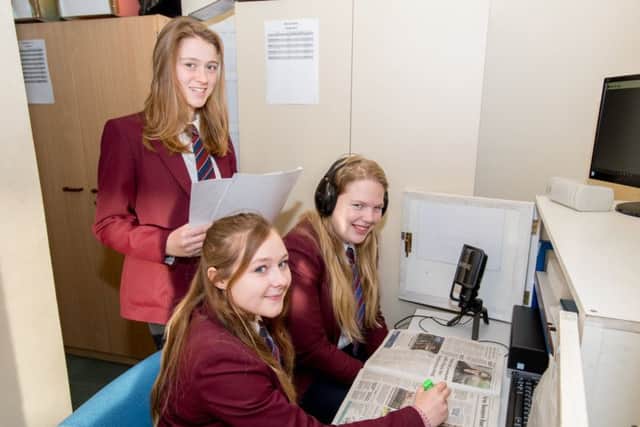 Three of the students from QEGS helping re-launch the Talking Newspaper.