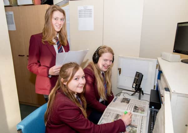 Three  of the  students from QEGS helping re-launch the Talking Newspaper.