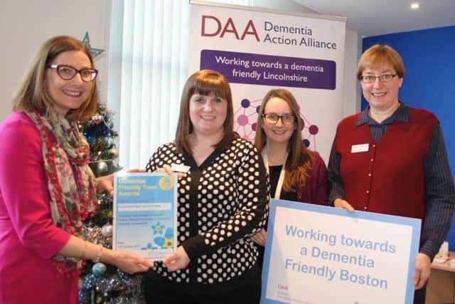 Davina Hellon, of Alzheimers Society, left, presents Chattertons Solicitors with its award.