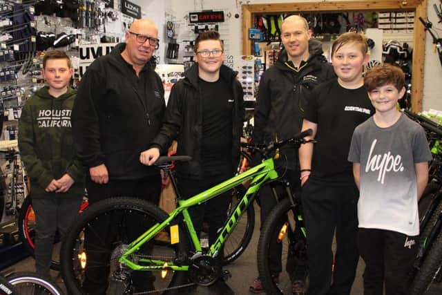 Jack Bennett (centre) with his friends Leon Jones, Bradley Perkins and Charly Kingston, alongside Trevor Brown from Louth Independent Traders and Jon Carter from Louth Cycle Centre.
