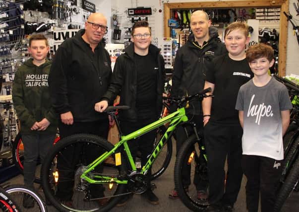 Jack Bennett (centre) with his friends Leon Jones, Bradley Perkins and Charly Kingston, alongside Trevor Brown from Louth Independent Traders and Jon Carter from Louth Cycle Centre.