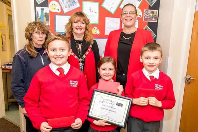 Headteacher Alison Hurrell, Councillor Sarah Devereux (judge of the competition), and Kayleigh Reynolds (Lovelle Estate Agent branch partner). Front row: Haydn Whitham (2nd prize, £50), Isla Willows (1st prize, £75) and Joshua Kingham (3rd prize, £35).
