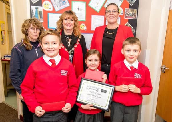 Headteacher Alison Hurrell, Councillor Sarah Devereux (judge of the competition), and Kayleigh Reynolds (Lovelle Estate Agent branch partner). Front row: Haydn Whitham (2nd prize, Â£50), Isla Willows (1st prize, Â£75) and Joshua Kingham (3rd prize, Â£35).