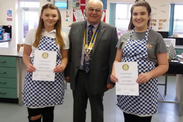 Sleaford Rotary President John Elkington with the two finalists from Ruskington's St Georges campus in the Rotary Young Chef competition - Ebony Coulam (left) and Jessica Argyle. EMN-171229-142431001