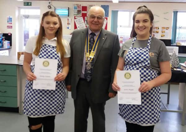 Sleaford Rotary President John Elkington with the two finalists from Ruskington's St Georges campus in the Rotary Young Chef competition - Ebony Coulam (left) and Jessica Argyle. EMN-171229-142431001