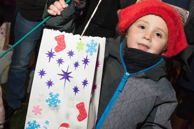 Freddie Edwards, three, from Ruskington holds a lantern.