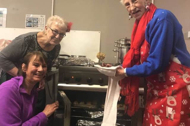 Volunteers Jean Allen, Shirley Noble and Korallou Antoniou check the oven ahead of the festive meal for the homeless at the Storehouse in Skegness. ANL-171227-152652001