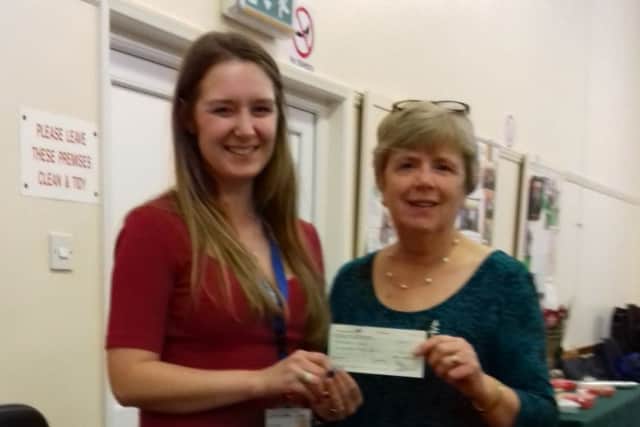 Elaine Whetton (right), pictured presenting a cheque for Â£350 to Amy Bailey from St Barnabass Hospice.