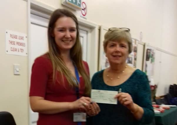 Elaine Whetton (right), pictured presenting a cheque for Â£350 to Amy Bailey from St Barnabass Hospice.