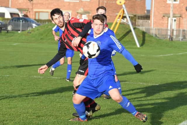 Swineshead Reserves' Dean Grainger and Sam Brader of Woodhall in action.