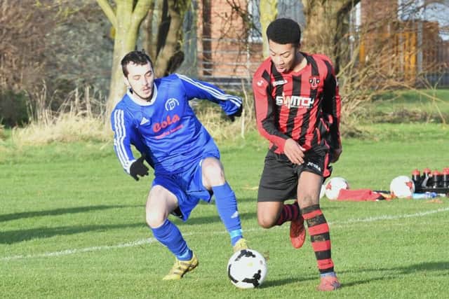 Swineshead's Lee Bradley battles with Woodhall's Blake Kenneally-Forrester.