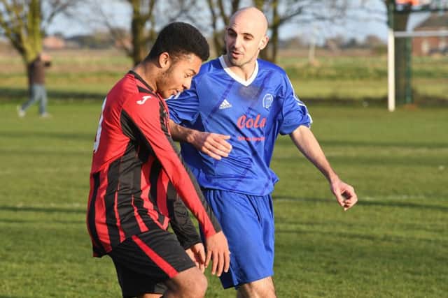 Swineshead Res (blue) v Woodhall Spa Utd (red). Blake Kenneally-Forrester (red), Giles Favell (blue).