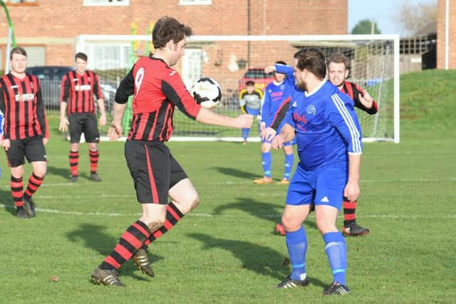 Swineshead Res (blue) v Woodhall Spa Utd (red). Michael Woods (blue), Jack Draper (red).