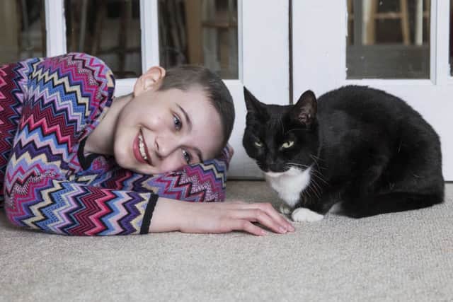 Evie Henderson, 11, with her pet cat Genie. Picture: Fabio De Paola/PA. EMN-180501-140220001