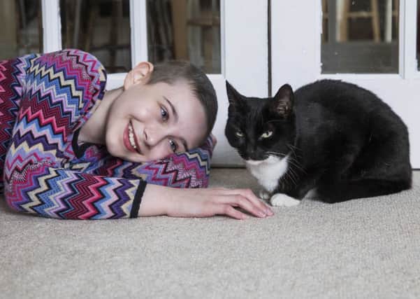 Evie Henderson, 11, with her pet cat Genie. Picture: Fabio De Paola/PA. EMN-180501-140220001