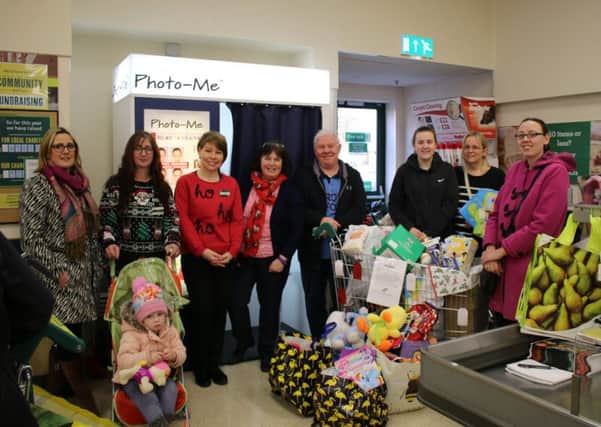 Pictured are Morrisons staff and reps from homestart and the food larder.