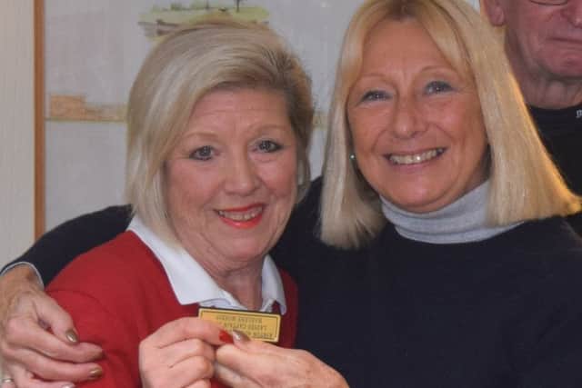 Gloria Bursnell presents Marlene Morris with her badge.