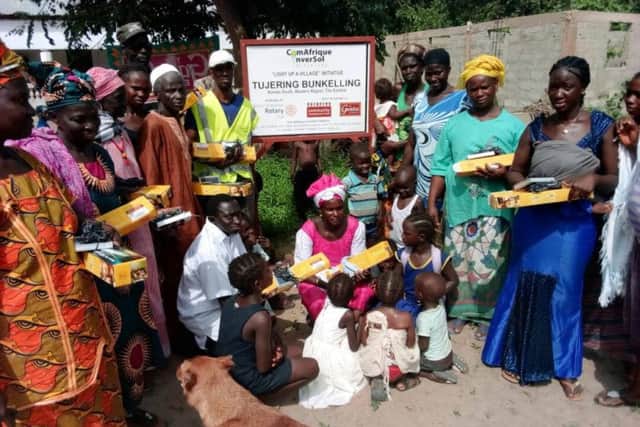 Villagers with their gift of lights from the Boston St Botolph Rotary Club.
