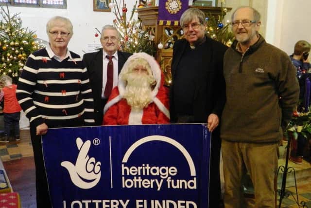 Belated Christmas gift: Father Christmas shares good news of a HLF Stage 2 Grant with the Vicar of Caistor, Canon Ian Robinson and church wardens, Alan Saxton and Val Waddington EMN-180115-112939001