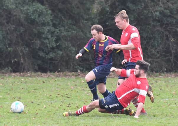 Ruskington's Ryan Norris and Matt Leonard try to apply the brakes to Railway Athletic's Tom Ruck EMN-180115-101845002