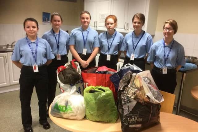 Some of the police cadets with their donations to the warm rail. F-jxdp62vgD7xvYjejxr