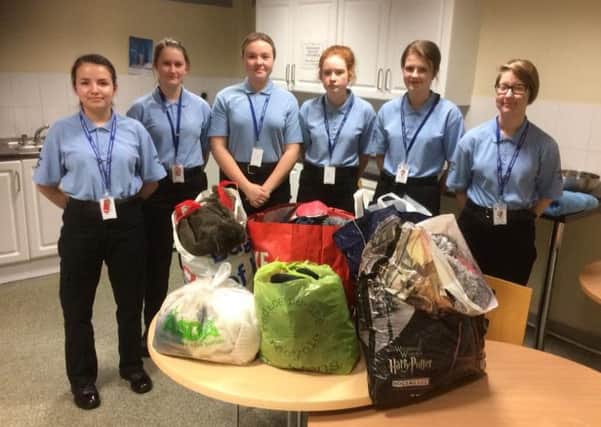 Some of the police cadets with their donations to the warm rail. F-jxdp62vgD7xvYjejxr