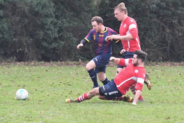 Railway Athletic (blue) v Ruskington Rovers (red). Tom Ruck (blue), Ryan Norris and Matt Leonard (red).