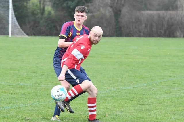 Railway Athletic (blue) v Ruskington Rovers (red). Harry Cramfield (blue), Ash Farmer (red).