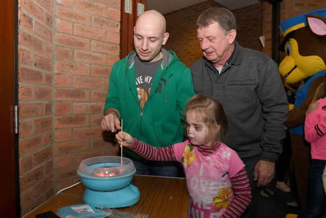 International Day at St Christophers Church on Fenside Road. L-R Patryk Delong, Trevor Baily - church warden, Julia Novicka 5 making candy floss. EMN-180115-112131001