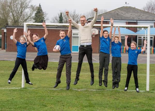 Jumping for joy: Mr Frost with pupils at Tattershall  Primary School.