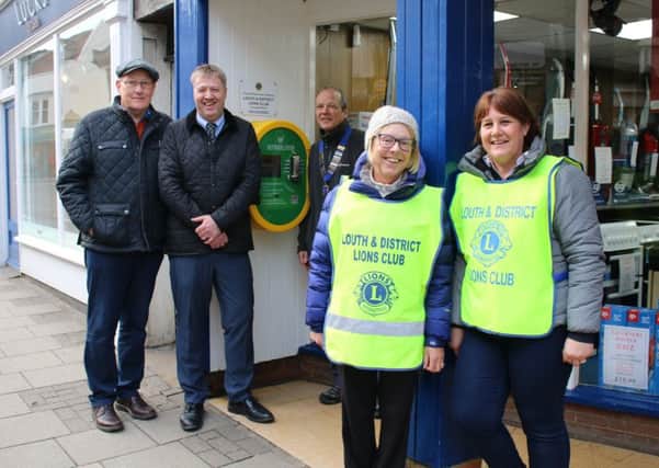 Trevor Blades of Faulkners (centre) pictured with members of the Louth and District Lions at the defibrillator.