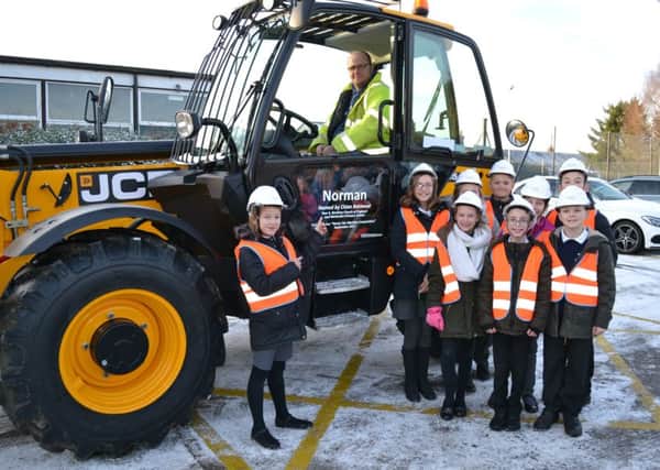 Chloe Betmead, of Bardney Church of England and Methodist School, meets the telehandler she named as part of Chestnut Homes competition EMN-180124-070747001