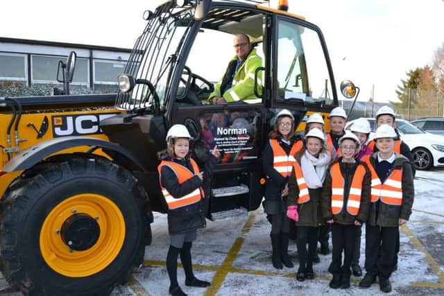 Chloe Betmead, of Bardney Church of England and Methodist School, meets the telehandler she named as part of Chestnut Homes competition EMN-180124-070747001