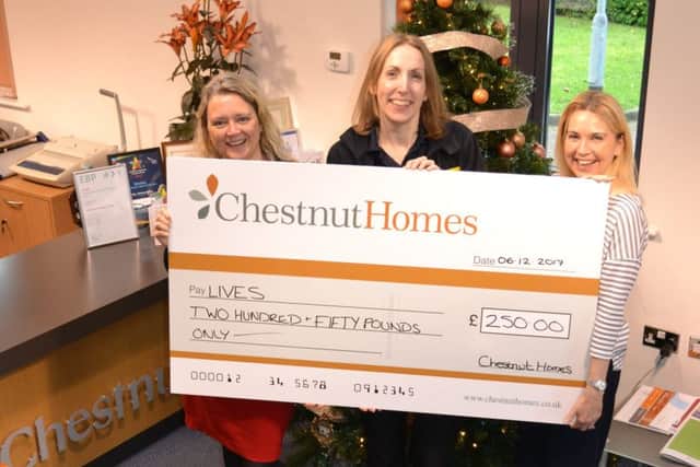 Steph Tilley (left) and Sarah Jowett (right) of Chestnut Homes present LIVES' Amy Rose (centre) with the housebuilderÂ’s donation.