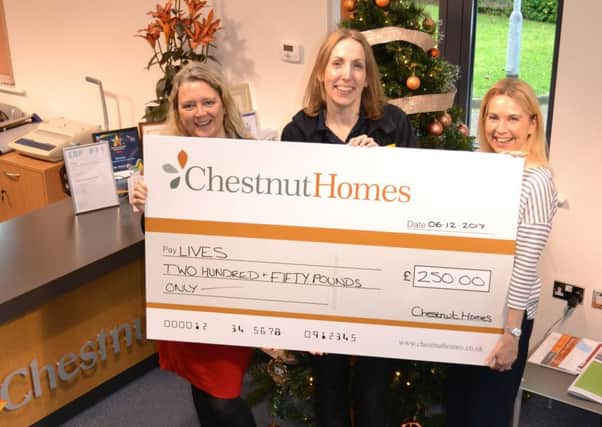 Steph Tilley (left) and Sarah Jowett (right) of Chestnut Homes present LIVES' Amy Rose (centre) with the housebuilderÂ’s donation.